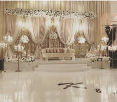 an elegant wedding setup with white flowers and chandeliers