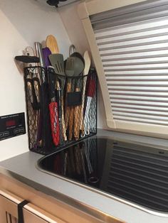 the rv camper storage organizer is hanging on the wall above the kitchen counter top