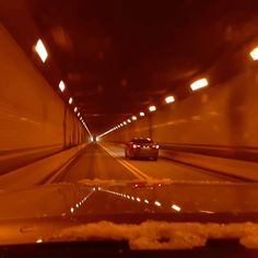 a car driving through a tunnel in the dark