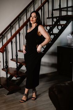 a woman standing in front of a stair case