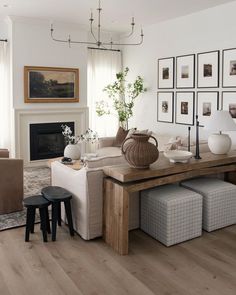 a living room filled with furniture and pictures on the wall