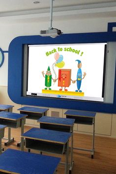 an empty classroom with blue desks and chairs in front of a large screen that says back to school