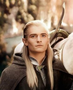 a man with long white hair wearing a cape