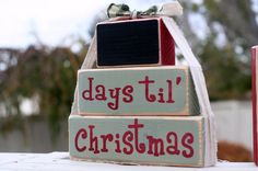 two wooden blocks that say days till christmas and have bows on them, sitting next to each other