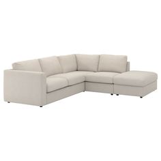 a white sectional couch sitting on top of a white floor