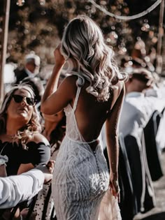 the back of a woman's dress as she stands in front of other people