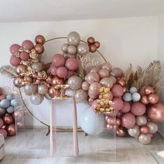 a room filled with balloons and decorations on top of a white table next to a couch