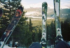 two snowboarders with their feet up in the air