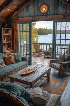 a living room filled with furniture next to a lake