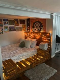 a bedroom with a bed made out of pallet wood and lights on the headboard