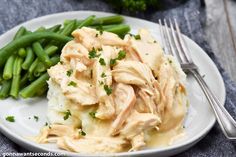 a white plate topped with mashed potatoes and green beans