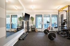 a home gym with mirrors and exercise equipment