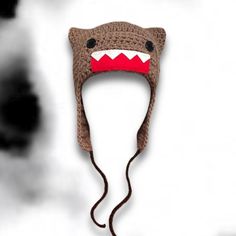 a crocheted hat with a shark's teeth on it is shown in front of a black and white background