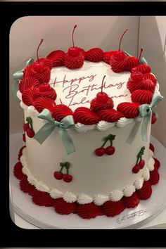 a birthday cake decorated with cherries and the words happy birthday