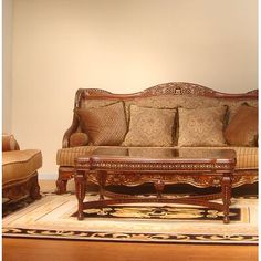 a living room filled with lots of furniture and pillows on top of a wooden floor