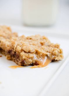 an oatmeal cookie bar sitting on top of a white plate