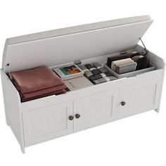 a white storage bench with drawers and items in it