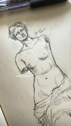 a pencil drawing of a man's torso on paper next to a marker pen