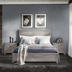 a bedroom with gray walls and white bedding, two framed pictures on the wall