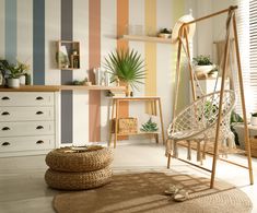 a living room filled with furniture and colorful striped wallpaper on the walls, along with a hammock chair