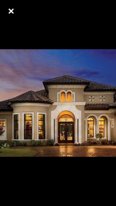 an image of a house at night with lights on the front door and windows in the middle