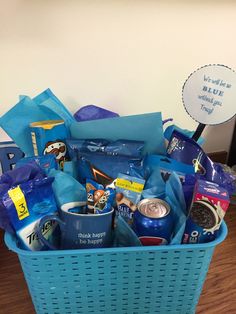 a blue basket filled with coffee and snacks