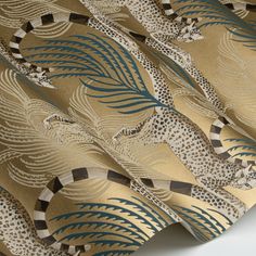 a close up view of a curtain with leopards and palm leaves on the side