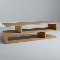 two wooden shelves sitting on top of each other in front of a white wall and floor