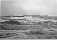 black and white photo of waves crashing on the beach