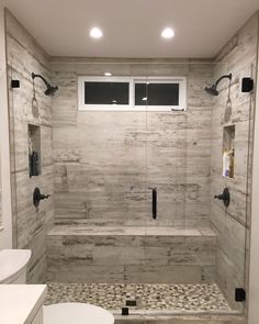 a bathroom with a walk in shower next to a toilet