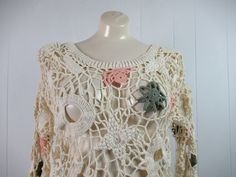 "Vintage 1980s wide net crochet shirt blouse with flower and circle design. Made by One Step Up. Size large. Actual measurements are: 40\" at the bust 37\" at the waist 19.5\" shoulder to shoulder 21\" shoulder to end of cuff 26\" overall length In very good condition." Vintage Cream Crochet Top With Trim, Vintage Cream Crochet Top With Crochet Trim, Vintage Cream Crochet Top, Vintage Handmade Tops For Summer, Vintage Open Knit Tops For Summer, Handmade Vintage Tops For Summer, Handmade Vintage Summer Tops, Vintage Cream Lace Crochet Top, Spring Vintage Lace Crochet Top