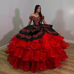 Command attention on your special day with this breathtaking Red Off-the-Shoulder Quinceanera Dress. This gown features a regal ball gown silhouette that cascades into a dramatic chapel train. The romantic off-the-shoulder neckline frames your shoulders beautifully, exuding elegance and charm. It is crafted from soft tulle fabric and is adorned with intricate appliques and playful ruffles, adding depth and texture to the voluminous skirt. The classic lace-up back ensures a secure and adjustable Red Fitted Gown For Debutante Ball, Fitted Red Gown For Debutante Ball, Fitted Red Ball Gown For Debutante Ball, Red Quinceanera Dress With Fitted Bodice For Gala, Red Gown For Debutante Ball, Red Ruffled Ball Gown Dress, Red Dress For Debutante Ball, Fitted Ball Gown With Attached Cancan For Quinceanera, Fitted Red Quinceanera Dress For Gala