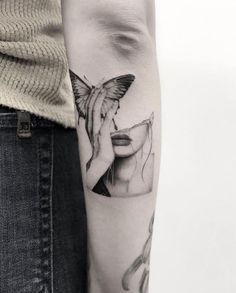 a woman's face with a butterfly on her arm