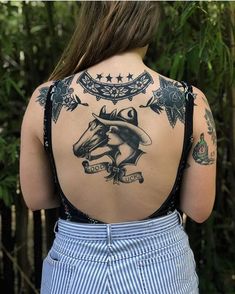 a woman with a horse tattoo on her back