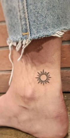 a small sun and moon tattoo on the ankle