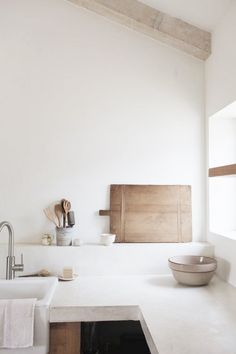 a kitchen with a sink, counter top and wooden utensils