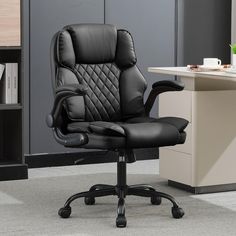 an office chair with black leather upholstered back and arms sits in front of a bookcase