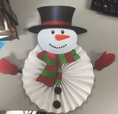 a snowman made out of paper on top of a desk