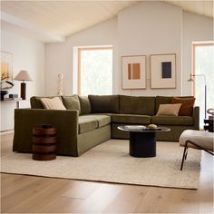 a living room filled with furniture and a large rug on top of a hard wood floor