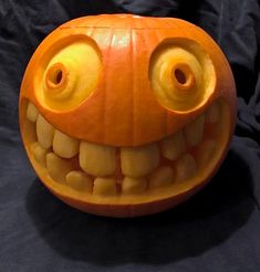 a carved pumpkin with eyes and teeth on it