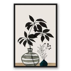 a black and white vase with plants in it