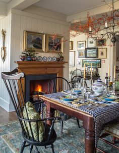 a dining room with a table and chairs next to a fire place in the fireplace