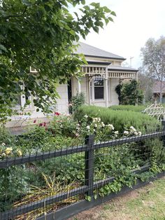 a fenced in garden with lots of flowers