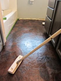 a mop laying on the floor in a bathroom