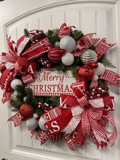 a christmas wreath is hanging on the front door