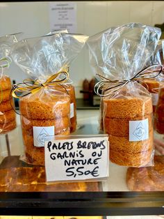 several bags of food sitting on top of a counter next to each other in front of a display case