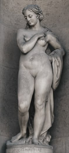 an image of a statue that is in the shape of a female torso and hands on her chest