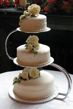 three tiered wedding cake with white flowers on top