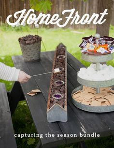 there is a cake bar on the table with marshmallows and other treats