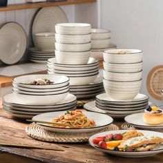 a table topped with lots of plates and bowls filled with different types of food on top of it